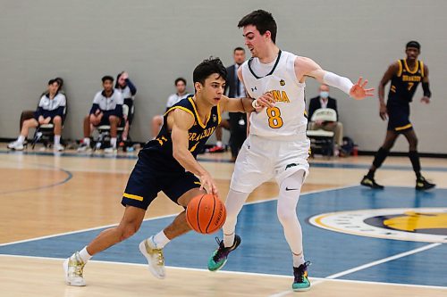 Travis Hamberger of the Brandon University Bobcats drives the ball past the University of Regina Cougars Benjamin Hillis in a Canada West men&#x573; basketball game at the Healthy Living Centre Saturday. (Chelsea Kemp/The Brandon Sun)