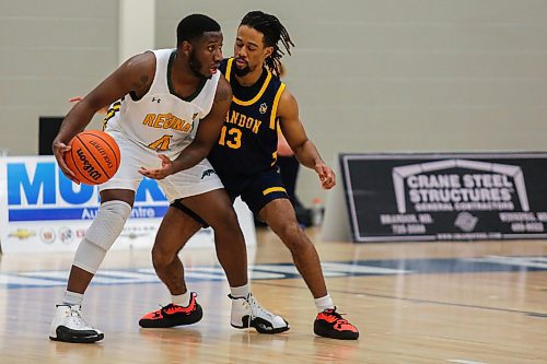 Malik Lewis of the Brandon University Bobcats defends against the University of Regina Cougars Josiah Thomas in a Canada West men&#x573; basketball game at the Healthy Living Centre Saturday. (Chelsea Kemp/The Brandon Sun)