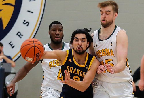 Sultan Halder Bhatti of the Brandon University Bobcats battles the University of Regina Cougars Nick Barnard, left, and Hayden Collier for the ball in a Canada West men&#x573; basketball game at the Healthy Living Centre Saturday. (Chelsea Kemp/The Brandon Sun)