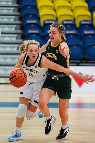 Piper Ingalls of the Brandon University Bobcats drives the ball past the University of Regina Cougars Madeleine Tell in a Canada West women&#x573; basketball game at the Healthy Living Centre Friday. (Chelsea Kemp/The Brandon Sun)