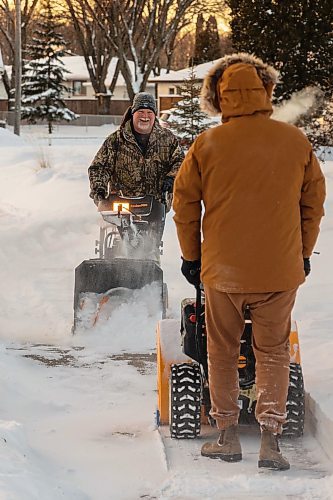 Don Carnegie, left, and Bryden Hutlet clear the sidewalk of snow Saturday.(Chelsea Kemp/The Brandon Sun)