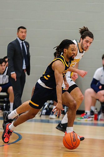 Malik Lewis of the Brandon University Bobcats brings the ball down the court followed by the University of Regina Cougars Nick Barnard in a Canada West men&#x573; basketball game at the Healthy Living Centre Saturday. (Chelsea Kemp/The Brandon Sun)