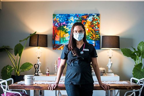 MIKAELA MACKENZIE / WINNIPEG FREE PRESS

Registered nurse April Intertas poses for a portrait in her home in Winnipeg on Thursday, Jan. 20, 2022. She moved to Manitoba from the Philippines to be a nurse here, and has worked in HSC's COVID red zone during the pandemic. For Chris Kitching story.
Winnipeg Free Press 2022.