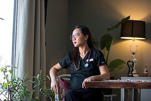 MIKAELA MACKENZIE / WINNIPEG FREE PRESS

Registered nurse April Intertas poses for a portrait in her home in Winnipeg on Thursday, Jan. 20, 2022. She moved to Manitoba from the Philippines to be a nurse here, and has worked in HSC's COVID red zone during the pandemic. For Chris Kitching story.
Winnipeg Free Press 2022.