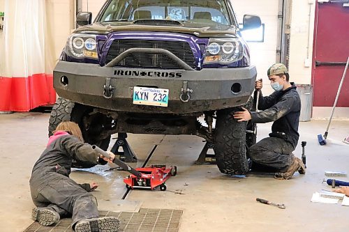 Grade 11 students Zander Beaudry and Asher Jackson torque the wheels of a 2006 Toyota Tacoma on Thursday morning at Crocus Plains Regional Secondary School's Automotive Technology department. (Kyle Darbyson/The Brandon Sun)