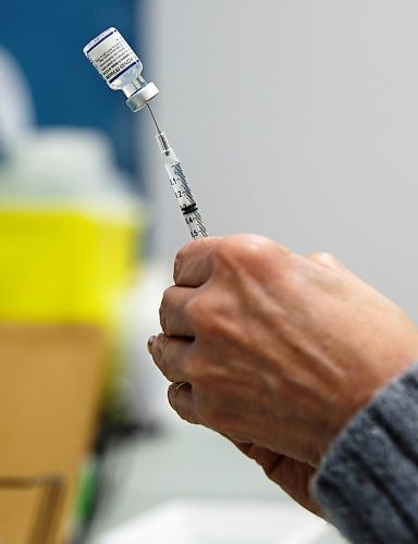 MIKE DEAL / WINNIPEG FREE PRESS
Registered nurse, Irene Par&#xe9;, loads her needles with the Pfizer BioNTech vaccine at her station before the start of her day Friday morning.
Ma Mawi Wi Chi Itata Centre vaccine clinic at 363 McGregor Street, brings in a lot of community support and Indigenous tradition including a morning smudge of the vaccines. The atmosphere of togetherness and one-on-one support has helped many in the area who may be wary of getting the vaccine.
See Melissa Martin story
220121 - Friday, January 21, 2022.