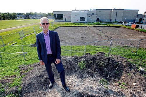 BORIS MINKEVICH / WINNIPEG FREE PRESS Pembina Trails School Division Superintendent of Education Ted Fransen poses on top of a  hill made of the earth that was removed to make room for more new portable classrooms at Fort Richmond Collegiate. Behind him is the build site and the school. For Saturday story on overcrowding in schools.  NICK MARTIN STORY. Sept. 2, 2016