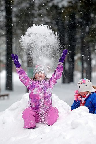 21012022
Sisters Quinn and Riley Holigroski play in the snow while having fun with family at the skating rink in Wasagaming on a mild Friday afternoon. (Tim Smith/The Brandon Sun)