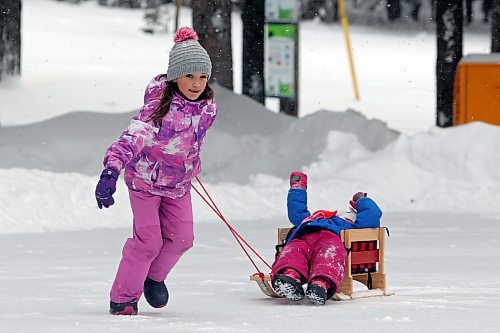 21012022
Quinn Holigroski, 7, pulls her little sister Riley, 3, on a sled while having fun with family at the skating rink in Wasagaming on a mild Friday afternoon. (Tim Smith/The Brandon Sun)