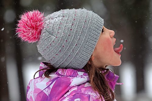 21012022
Quinn Holigroski, 7, tries to catch a snowflake on her tongue while having fun with family at the skating rink in Wasagaming on a mild Friday afternoon. (Tim Smith/The Brandon Sun)