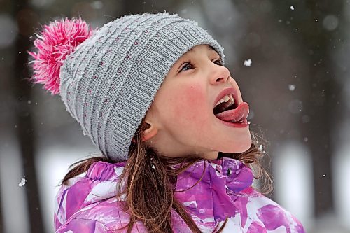 21012022
Quinn Holigroski, 7, tries to catch a snowflake on her tongue while having fun with family at the skating rink in Wasagaming on a mild Friday afternoon. (Tim Smith/The Brandon Sun)