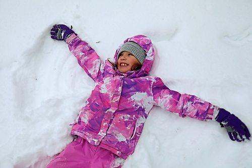 21012022
Quinn Holigroski, 7, makes snow angels while having fun with family at the skating rink in Wasagaming on a mild Friday afternoon. (Tim Smith/The Brandon Sun)