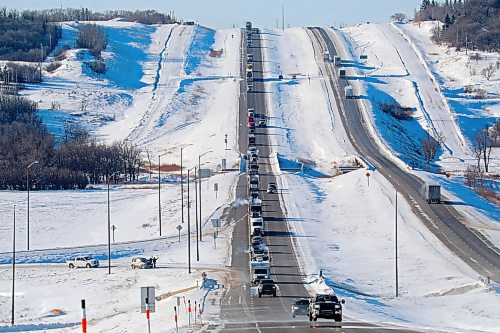25012022
The lead vehicles in the 'Freedom Rally'  convoy make their way through Grand Valley just west of Brandon on Tuesday demonstrating opposition to vaccine mandates. The convoy of at least hundreds of vehicles took over an hour to make its way through Brandon. (Tim Smith/The Brandon Sun)