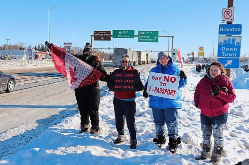 Westman residents Ann Foote, Colleen Farmer, Cindy Kempthorne and Amanda Flannery show their support for the Freedom Rally convoy as it makes its way through Brandon on Tuesday morning. The group had to endure an extreme cold warning with temperatures that hovered around -30 C. (Kyle Darbyson/The Brandon Sun)