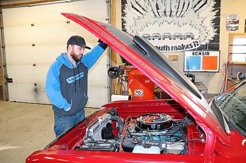 Ryan Villers pops the hood of his 1971 Dodge Demon on Thursday morning to check on the 383 big block engine that powers it. (Kyle Darbyson/The Brandon Sun) 