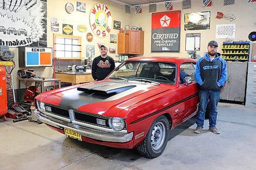 Mike and Ryan Villers pose for a photo in front of a 1971 Dodge Demon inside the former's Shilo-area garage on Thursday morning. The father-duo spent seven years rebuilding this classic muscle car from scratch. (Kyle Darbyson/The Brandon Sun)
