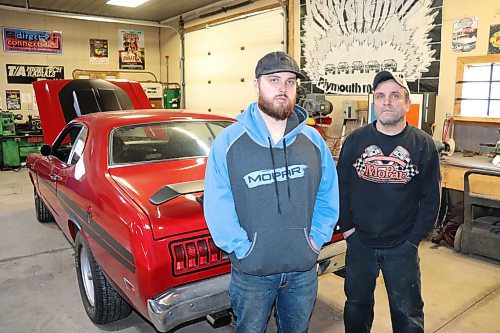 Ryan and Mike Villers pose for a photo in front of a 1971 Dodge Demon inside the latter's Shilo-area garage on Thursday morning. The father-duo spent seven years rebuilding this classic muscle car from scratch. (Kyle Darbyson/The Brandon Sun)