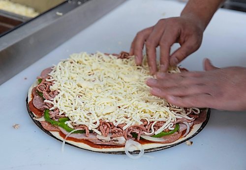 JESSICA LEE / WINNIPEG FREE PRESS

Jack Colombe, co-owner of Thompson-Style Pizza, makes a Shane Special on January 28, 2022, named for Colombe&#x2019;s brother who took his own life three years ago.

Reporter: Dave




