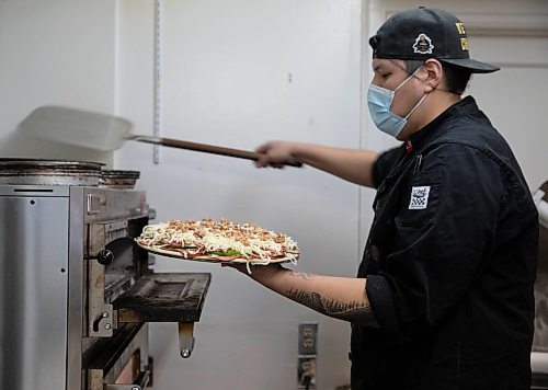 JESSICA LEE / WINNIPEG FREE PRESS

Jack Colombe, co-owner of Thompson-Style Pizza, makes a Shane Special on January 28, 2022, named for Colombe&#x2019;s brother who took his own life three years ago.

Reporter: Dave




