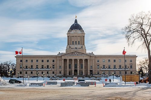 MIKE DEAL / WINNIPEG FREE PRESS
A front-end loader pushes concrete barriers into position in anticipation of the &quot;trucker&quot; protest Friday morning at the Manitoba Legislative building.
220203 - Thursday, February 03, 2022.