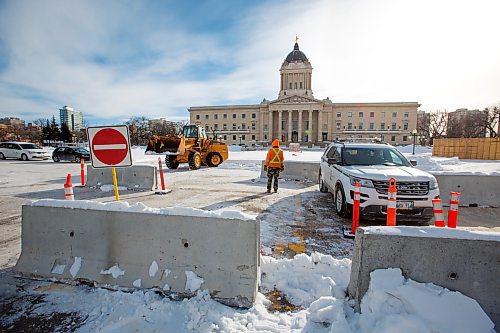 MIKE DEAL / WINNIPEG FREE PRESS
A front-end loader pushes concrete barriers into position in anticipation of the &quot;trucker&quot; protest Friday morning at the Manitoba Legislative building.
220203 - Thursday, February 03, 2022.