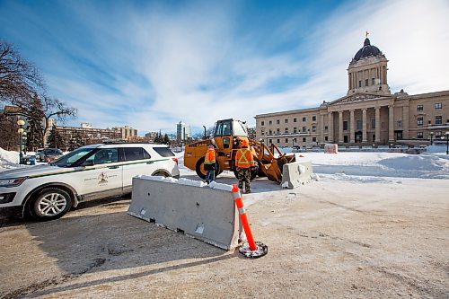 MIKE DEAL / WINNIPEG FREE PRESS
A front-end loader pushes concrete barriers into position in anticipation of the &quot;trucker&quot; protest Friday morning at the Manitoba Legislative building.
220203 - Thursday, February 03, 2022.