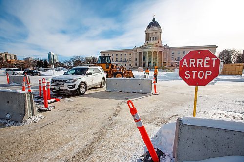 MIKE DEAL / WINNIPEG FREE PRESS
A front-end loader pushes concrete barriers into position in anticipation of the &quot;trucker&quot; protest Friday morning at the Manitoba Legislative building.
220203 - Thursday, February 03, 2022.