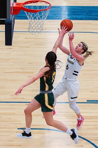 Chelsea Misskey of the Brandon University Bobcats drives for the net against the University of Regina Cougars Jade Belmore in a Canada West womenճ basketball game at the Healthy Living Centre Friday. (Chelsea Kemp/The Brandon Sun)