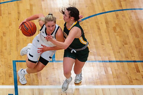 Reetta Tulkki of the Brandon University Bobcats drives for the net against University of Regina Cougars Cara Misskey in a Canada West women&#x573; basketball game at the Healthy Living Centre Friday. (Chelsea Kemp/The Brandon Sun)