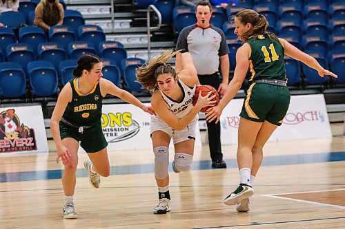 Adrianna Proulx of the Brandon University Bobcats races past the University of Regina Cougars Maddy Seida, left, and Zoe Hartmann in a Canada West women&#x573; basketball game at the Healthy Living Centre Friday. (Chelsea Kemp/The Brandon Sun)