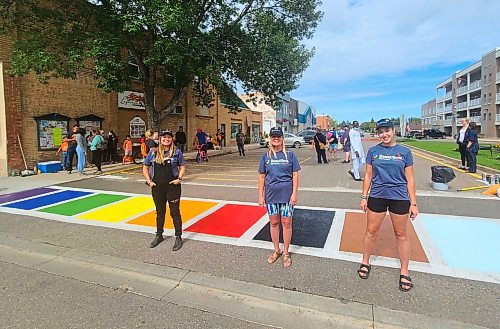 The first-ever Souris Pride Committee was recently formed by (L-R) Cassie Quadrelli, Karen Kempe and Caleigh Walker. The trio proudly stands in front of the completed Pride crosswalk, which is meant to symbolize safety, progression and inclusivity. (Jillian Austin/The Brandon Sun)