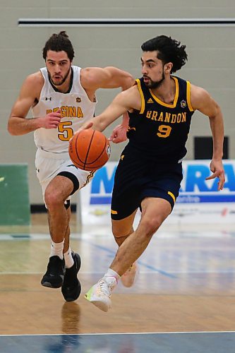 Sultan Halder Bhatti of the Brandon University Bobcats brings the ball down the court against the University of Regina Cougars Nick Barnard in a Canada West men&#x573; basketball game at the Healthy Living Centre Saturday. (Chelsea Kemp/The Brandon Sun)