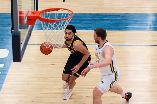 Sultan Halder Bhatti of the Brandon University Bobcats lines up for a shot against the University of Regina Cougars Carter Millar in a Canada West men&#x573; basketball game at the Healthy Living Centre Saturday. (Chelsea Kemp/The Brandon Sun)