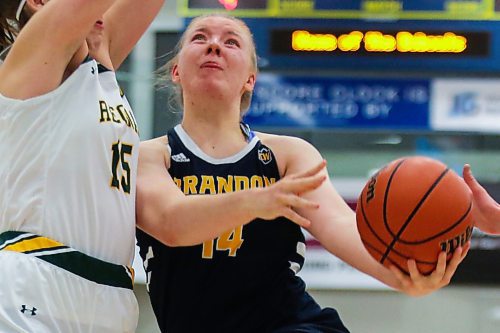 Kelsey Starchuck of the Brandon University goes for a layup against the University of Regina Cougars Julie Vydrova in a Canada West women&#x573; basketball game at the Healthy Living Centre Saturday. (Chelsea Kemp/The Brandon Sun)