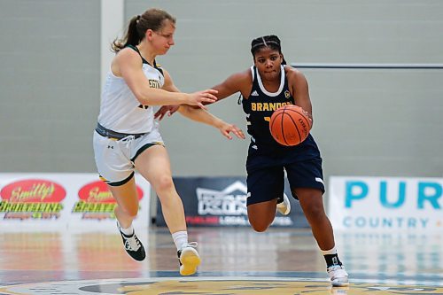 Sydney Teece of the Brandon University Bobcats brings the ball down the court past the University of Regina Cougars Zoe Hartmann in a Canada West women&#x573; basketball game at the Healthy Living Centre Saturday. (Chelsea Kemp/The Brandon Sun)