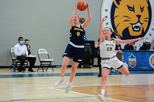 Josie Grift  of the Brandon University Bobcats races the University of Regina Cougars Kaitlyn Tonita for the ball in a Canada West women&#x573; basketball game at the Healthy Living Centre Saturday. (Chelsea Kemp/The Brandon Sun)