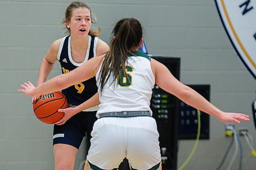 Josie Grift of the Brandon University Bobcats protects the ball from the University of Regina Cougars Cara Misskey in a Canada West women&#x573; basketball game at the Healthy Living Centre Saturday. (Chelsea Kemp/The Brandon Sun)