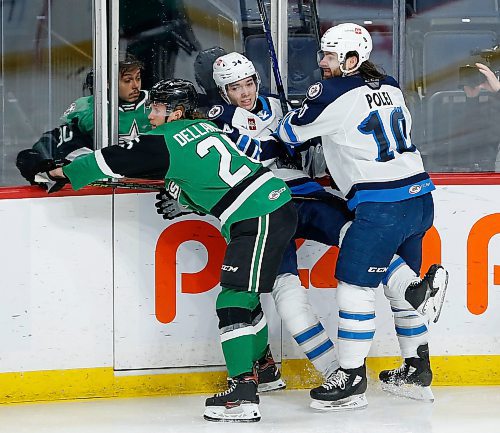 JOHN WOODS / WINNIPEG FREE PRESS
Manitoba Moose Ville Heinola (34), centre, gets sandwiched between Evan Polei (10) and Texas Stars Ty Dellandrea (25) in downtown Winnipeg, Sunday, February 6, 2022. 

Re: McIntyre