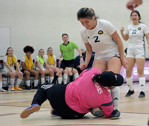 Brandon University Bobcats Emily Bussiere collides with Assiniboine Community College Cougars goalkeeper Tess Omeljanow during their Manitoba Colleges Athletic Conference women's futsal game at ACC on Sunday. The keeper left the game with 11:30 left and a 3-1 lead, but ACC lost 4-3. (Thomas Friesen/The Brandon Sun)