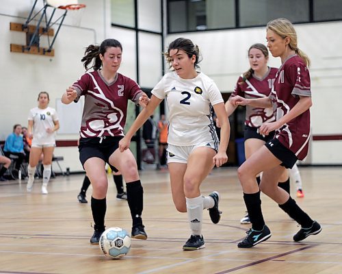 Brandon University Bobcats Emily Bussiere splits through Assiniboine Community College Cougars Calista Green, left, and Courtney Scott during their Manitoba Colleges Athletic Conference women's futsal game at ACC on Sunday. (Thomas Friesen/The Brandon Sun)