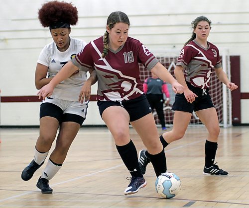 Brandon University Bobcats Kira Ireson, left, battles Assiniboine Community College Cougars Megan Beswitherick for the ball as Natalie Babcock looks on during their Manitoba Colleges Athletic Conference women's futsal game at ACC on Sunday. (Thomas Friesen/The Brandon Sun)