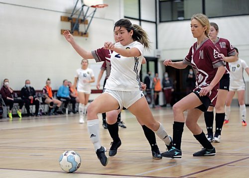 Brandon University Bobcats Emily Bussiere reaches to shoot as Assiniboine Community College Cougars Courtney Scott (11) defends during their Manitoba Colleges Athletic Conference women's futsal game at ACC on Sunday. (Thomas Friesen/The Brandon Sun)