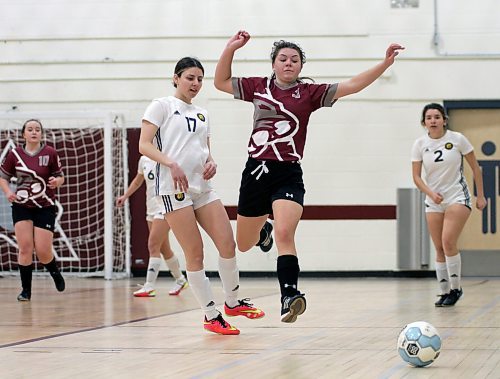 Brandon University Bobcats Ashley Robinson (17) and Assiniboine Community College Cougars Natalie Babcock race for the ball during their Manitoba Colleges Athletic Conference women's futsal game at ACC on Sunday. (Thomas Friesen/The Brandon Sun)