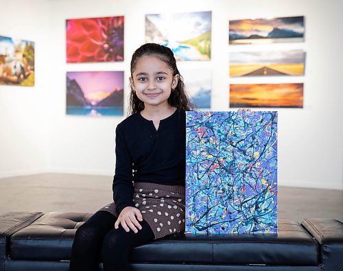 JESSICA LEE / WINNIPEG FREE PRESS

Nehal Safi, 7, is photographed at Cre8ery Gallery supporting her father artist Tameem Safi&#x2019;s show &#x2018;Through and Through&#x2019; on February 8, 2022. She holds a painting she made with help from her father.

Reporter: Ben




