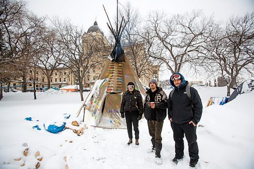 MIKE DEAL / WINNIPEG FREE PRESS
Volunteer Fire Keepers, Holly Enns (left) with her partner Daniel &#x201c;Kuya&#x201d; Caneda (right), with full-time Fire Keeper, John Butler (centre) outside the small&#xa0;tipi where the sacred fire has been burning on the grounds of the Manitoba Legislative building. 
See Melissa Martin story
220210 - Thursday, February 10, 2022.