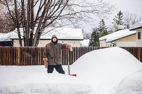 MIKAELA MACKENZIE / WINNIPEG FREE PRESS

Alex Wiebe, who loves embracing the winter elements, poses for a portrait by his backyard quinzhee in Winnipeg on Thursday, Feb. 10, 2022. . For Declan story.
Winnipeg Free Press 2022.