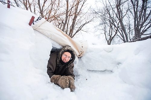 MIKAELA MACKENZIE / WINNIPEG FREE PRESS

Alex Wiebe, who loves embracing the winter elements, poses for a portrait in his backyard quinzhee in Winnipeg on Thursday, Feb. 10, 2022. . For Declan story.
Winnipeg Free Press 2022.