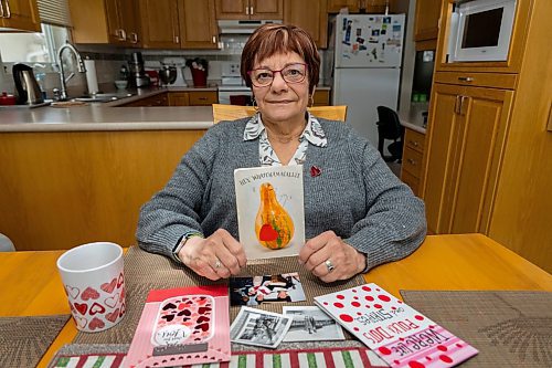 Brandonite Carol Enns holds a Valentine&#x573; Day card she has been mailing back and forth with her friend Chris Ranick for 60 years Thursday in her kitchen. (Chelsea Kemp/The Brandon Sun)