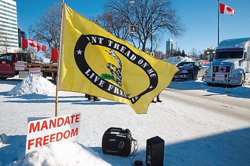 MIKE DEAL / WINNIPEG FREE PRESS
A version of the Gadsden flag flies from a snowbank amongst the protestors Friday morning in front of the Manitoba Legislative building. 
220211 - Friday, February 11, 2022.