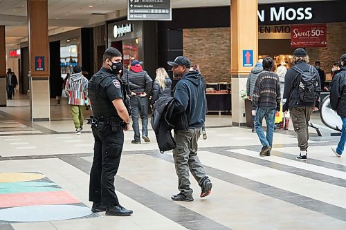 David Lipnowski / Winnipeg Free Press

A security guard speaks with a protester who walked around CF Polo Park Mall without the required face mask Saturday February 12, 2022.